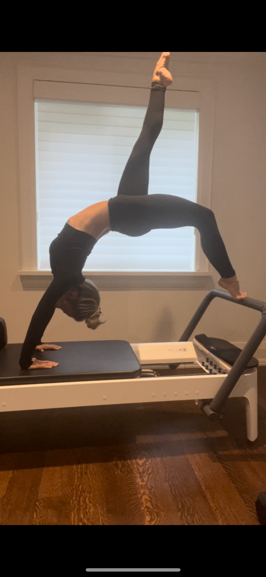 Marissa practicing reformer Pilates in a sunlit studio